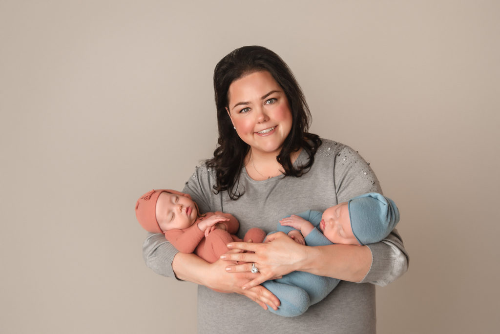 mom holds twins during Las Vegas Studio newborn portraits